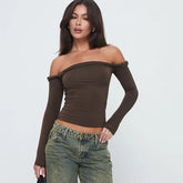 Woman wearing a brown off-shoulder top and jeans
